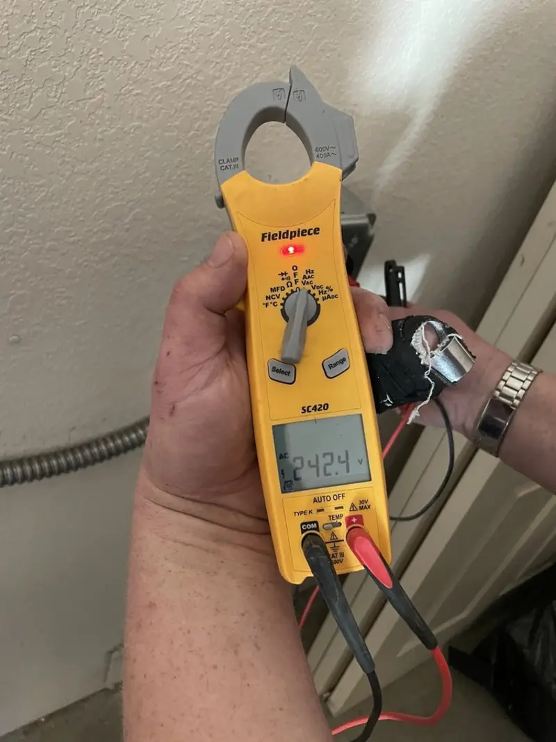 Voltage testing with clamp meter during Electrical Installation Services in Price